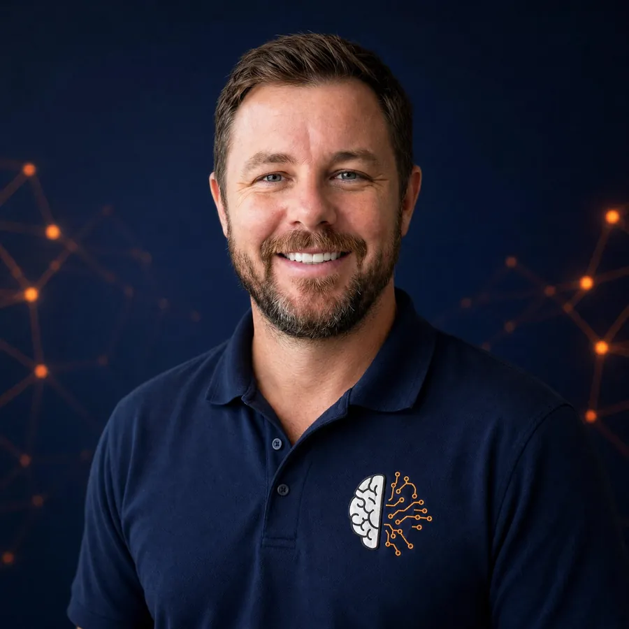 Troy Scott, founder of Hybrid AI Systems, in a navy polo with the half-brain half-circuit brand mark